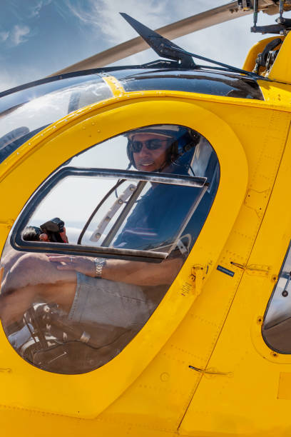 istock helicopter Arab pilot, flying a rescue chopper, wearing helmet and headset 2155442128