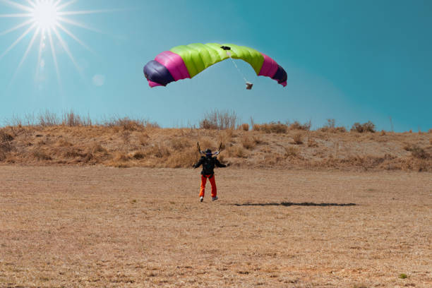 parachute jump, landing on the ground in the grass