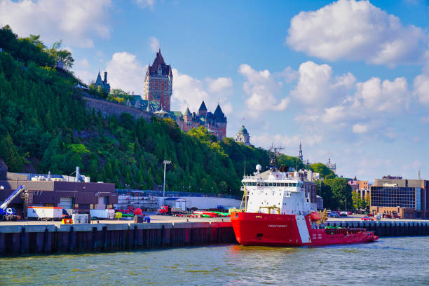 Quebec City,CanadaSeptember 4,2023-Canadian Coast Guard ship,Vincent Massey  with the Chateau Fairmont Frontenac Hotel in the background in this view from the cruise boat on the St.Lawrence river