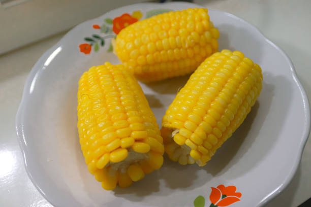 Pile of boiled corn on white plate