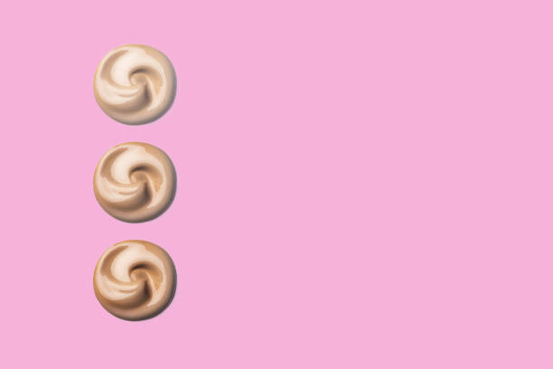 istock 3 Three foundation shade swatches, round shape. Make up smear swatch foundation smudge texture isolated on white background, swatches of cosmetics copy space 2155444654