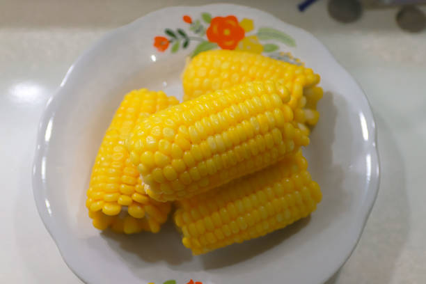 Pile of boiled corn on white plate