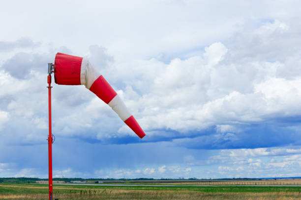 istock Weather vane in the airfield with grass and dramatic cloudy sky. 2155447650