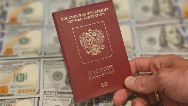 istock Russian passport on the background of us dollars 2155449125