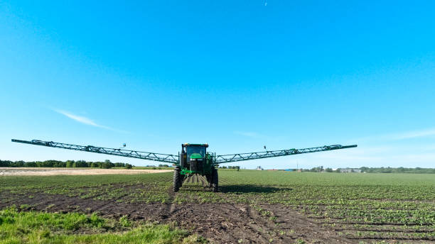 Large Agricultural Equipment Spraying Soybean Field