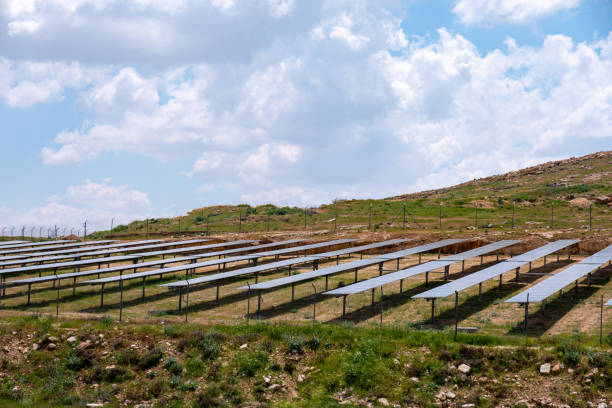 istock A solar farm is built on a hill under a cloudy sky, surrounded by nature, creating an environmentally friendly place to generate energy in harmony with the natural landscape 2155449840