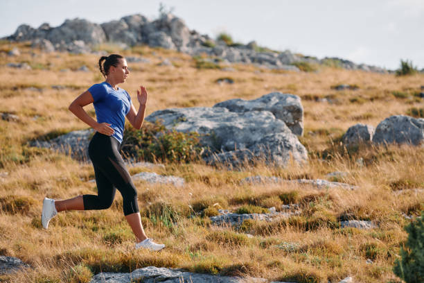 istock Empowered Runner Embracing Nature's Beauty on a Serene Morning Trail. 2155453037