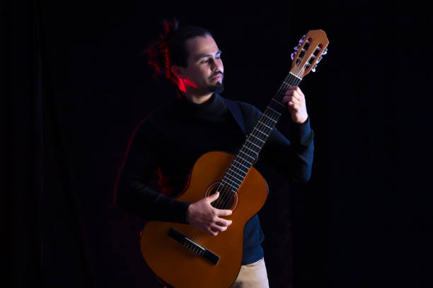 Musician tuning his instrumental guitar