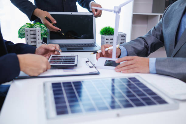 istock architects and investors discuss real estate projects using clean energy or solar cells within residential construction projects. Concept using clean energy in large residential construction projects. 2155462662