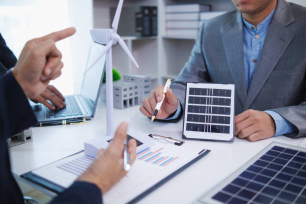 istock architects and investors discuss real estate projects using clean energy or solar cells within residential construction projects. Concept using clean energy in large residential construction projects. 2155462667