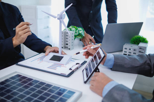 istock architects and investors discuss real estate projects using clean energy or solar cells within residential construction projects. Concept using clean energy in large residential construction projects. 2155462669