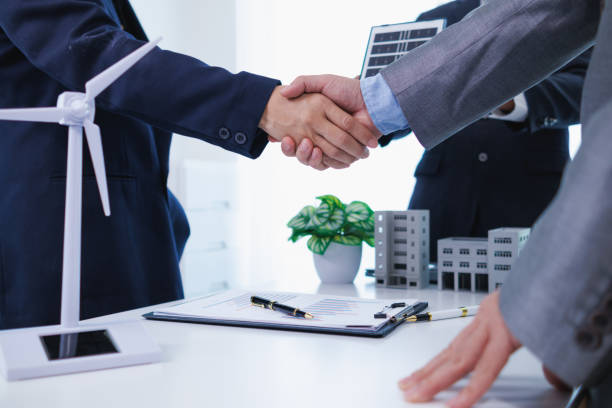 istock architects and investors discuss real estate projects using clean energy or solar cells within residential construction projects. Concept using clean energy in large residential construction projects. 2155462703