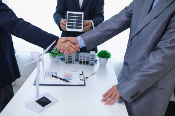 istock architects and investors discuss real estate projects using clean energy or solar cells within residential construction projects. Concept using clean energy in large residential construction projects. 2155462719