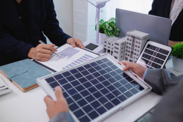 istock architects and investors discuss real estate projects using clean energy or solar cells within residential construction projects. Concept using clean energy in large residential construction projects. 2155462848