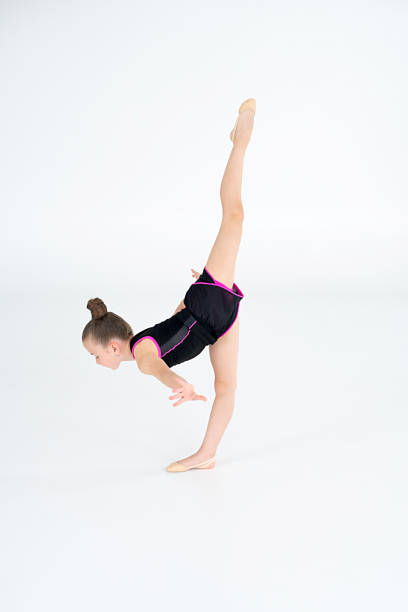 istock little gymnast athlete girl doing exercise 2155463775