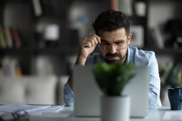 istock Thoughtful young businessman analyzing financial paper data. 2155467013