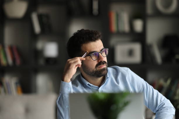 istock Head shot unhappy confused businessman in glasses looking using laptop 2155467703