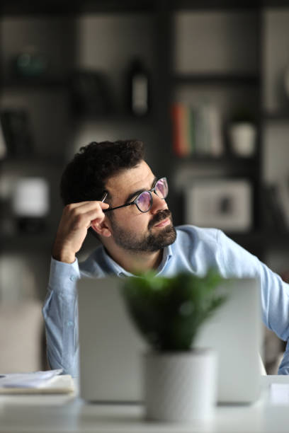 istock Head shot unhappy confused businessman in glasses looking using laptop 2155467743