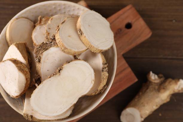 istock Cut horseradish roots on wooden table, top view 2155469262