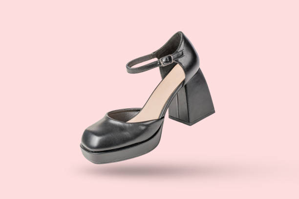 istock Modern Black High-Heeled Shoe on Pink Background with Stylish Ankle Strap 2155472912