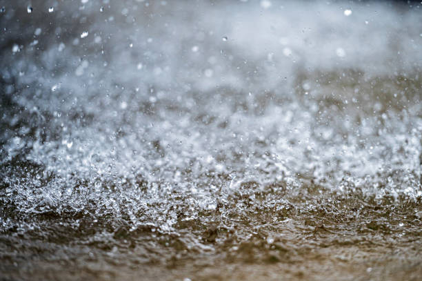 istock Water splashes on a blurred background. Drops of water fly in the air. Selective focus 2155473025