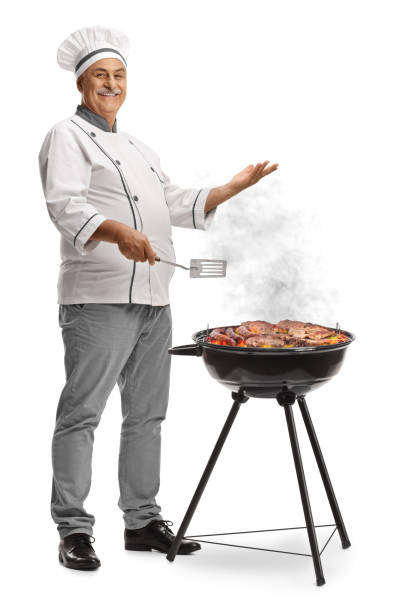 istock Mature male chef grilling meat on a bbq 2155474271