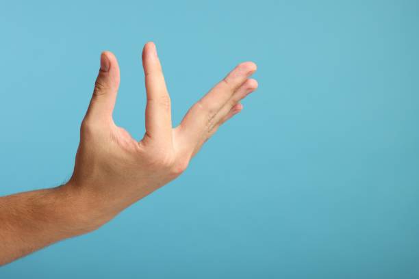 istock Man holding something in hand on light blue background, closeup. Space for text 2155475111