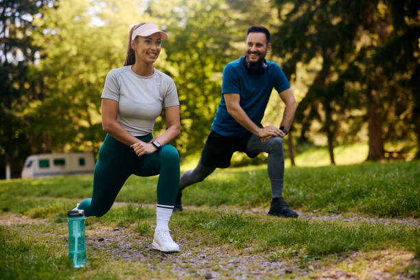 istock Happy athletic couple doing stretching exercises while during sports training in nature. 2155475438