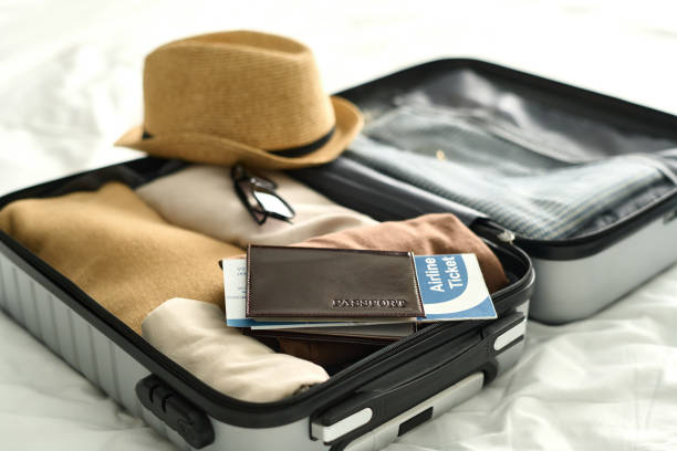 Open Suitcase with Passport and Airplane Ticket