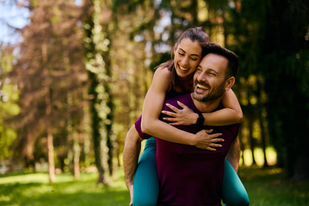 istock Happy sports couple piggybacking while exercising in nature. 2155476836