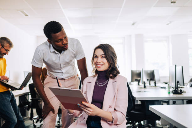 istock Woman with disability discussing marketing strategy with her diverse colleague 2155479089