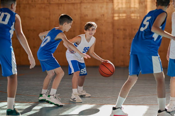 istock Junior basketball athletes practicing basketball game play on training 2155479173