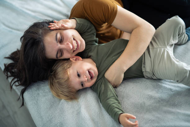 istock Playful little boy playing with his mom at home. 2155479564
