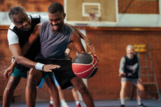 Excited friends playing basketball.