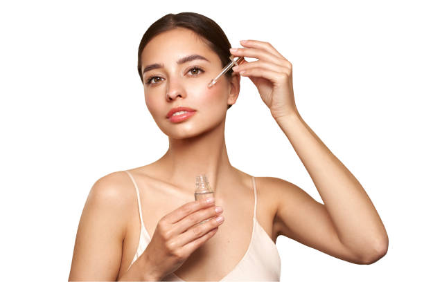 istock Young beautiful woman applying face serum 2155480841