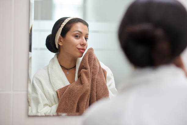 istock Woman Wiping Face with Towel 2155481836