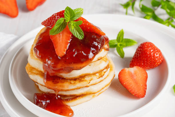 Mini pancakes with strawberry jam and strawberries