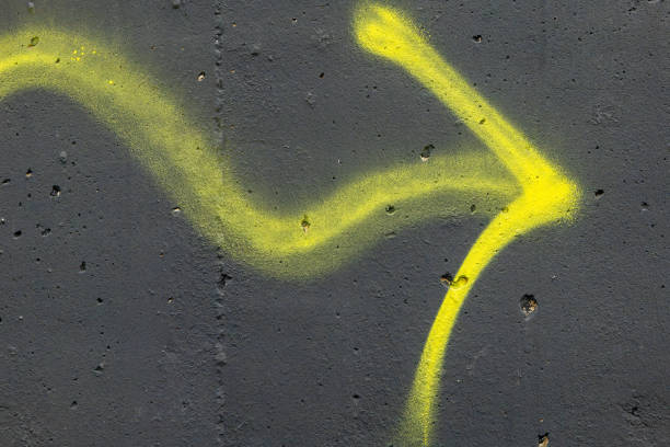 Graphic composition of arrow symbols and  data over abstract blurred lights. Dark background.