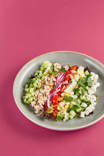 istock Fresh and Colorful Cobb Salad in a Bowl on Pink Background 2155482152