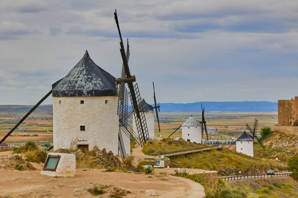 istock Old windmills in top of the hill in Consuegra Village 2155482425