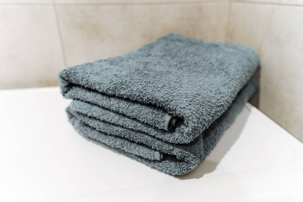 istock Grey linens stack on white counter, adding comfort and fashion to the room 2155484601