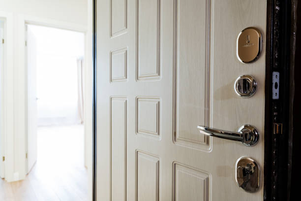 istock White door with chrome handle open to hallway in building 2155484622