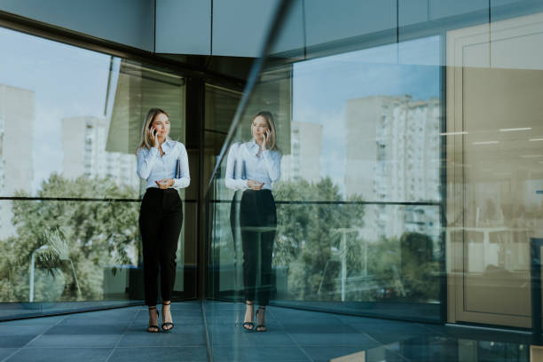 istock Professional woman standing in modern office building on a sunny day 2155484886