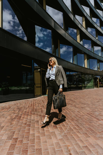 istock Business professional walking outside modern office building on a sunny day 2155484923