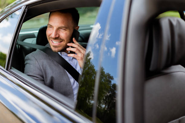 istock Joyful man sharing laughter on a phone call while driving in daylight 2155484925