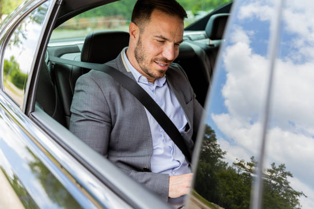 istock Business executive working on laptop in car during morning commute 2155484958