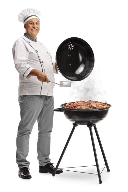 Chef grilling meat on a bbq and smiling