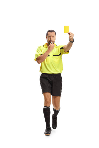 istock Referee running with a yellow card and blowing a whistle 2155485447