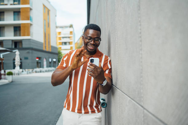 istock Smiling African American man on a video call outdoors 2155486979