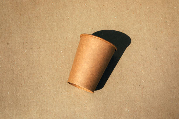 istock Paper cup on a brown cardboard background. Eco friendly, zero waste concept 2155487355